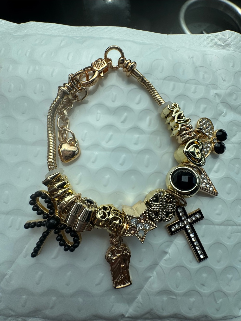 Gold and Black Charm Bracelet with Cross and Heart Pendants